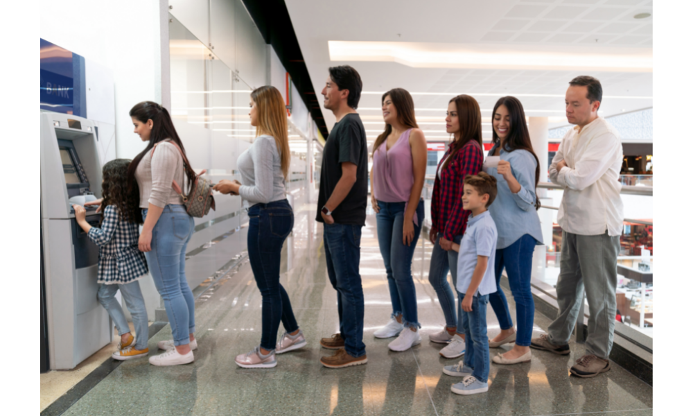 Pessoas na fila para um caixa eletrônico.