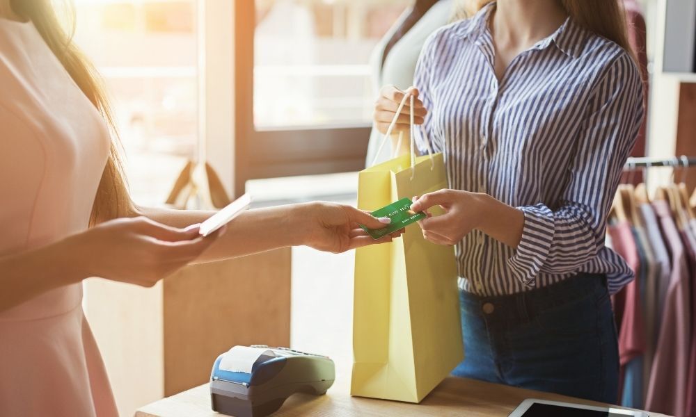 Mulher fazendo compra com cartão.