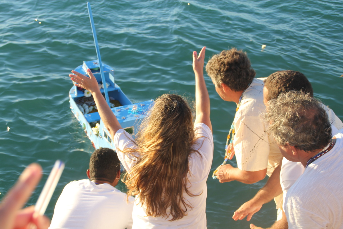 Pessoas fazendo oferenda para Iemanjá no mar