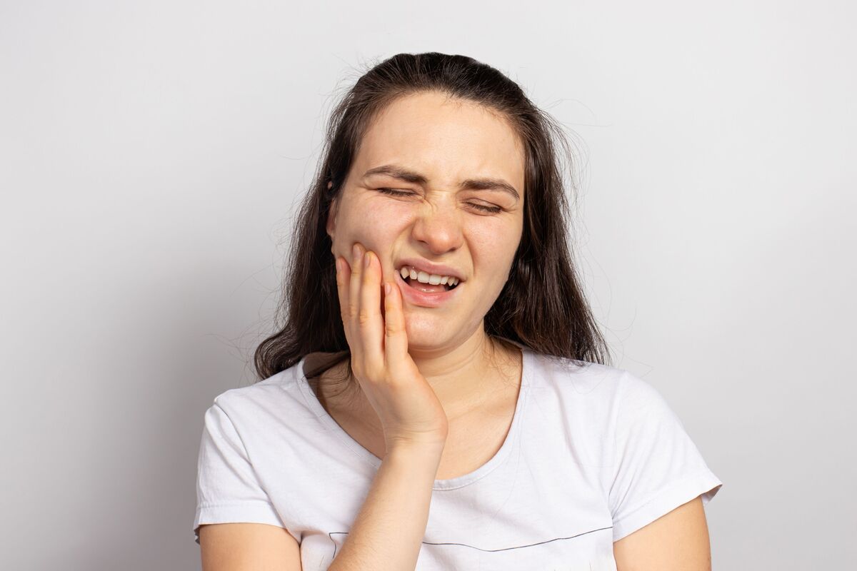 Mulher com dor nos dentes.