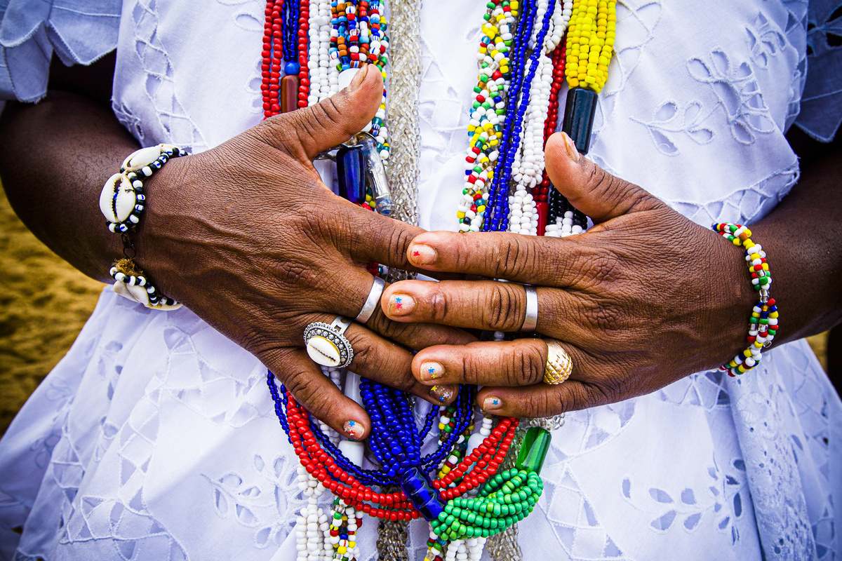 Mãe de santo com várias pulseiras e guias.