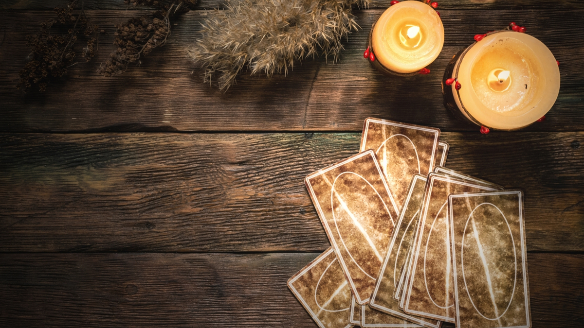 Cartas com velas em cima de uma mesa de madeira.