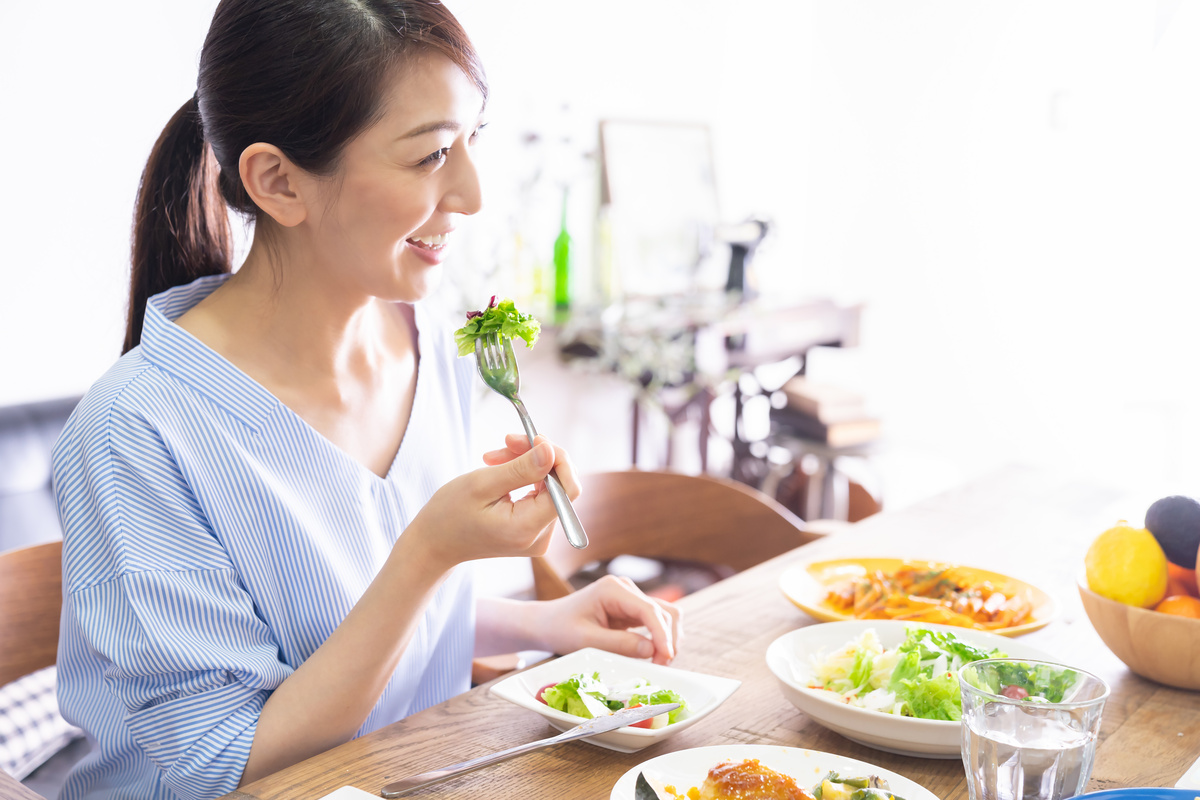 Mulher feliz comendo refeição saudável