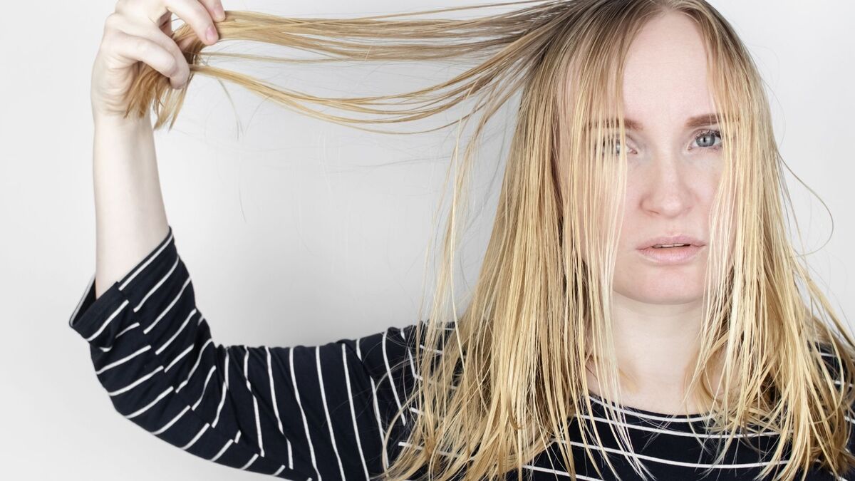 Mulher com cabelo oleoso.