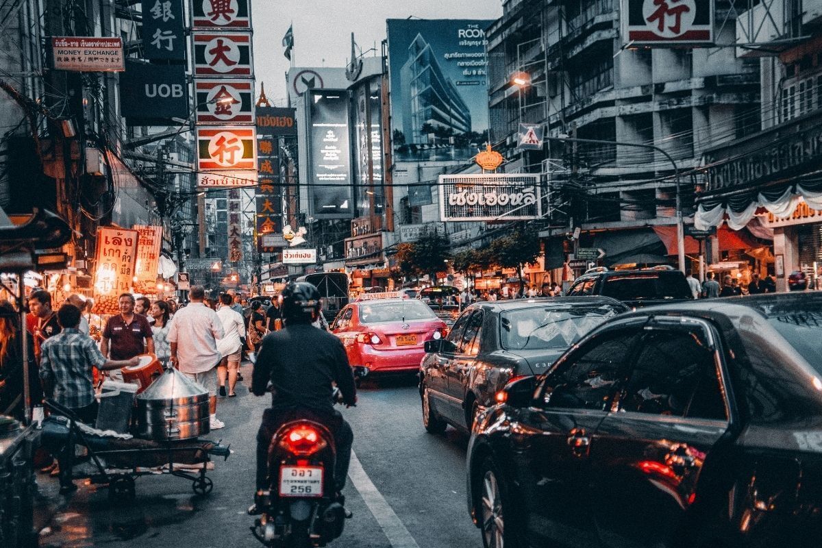 Ruas com muitos carros e motos passando.