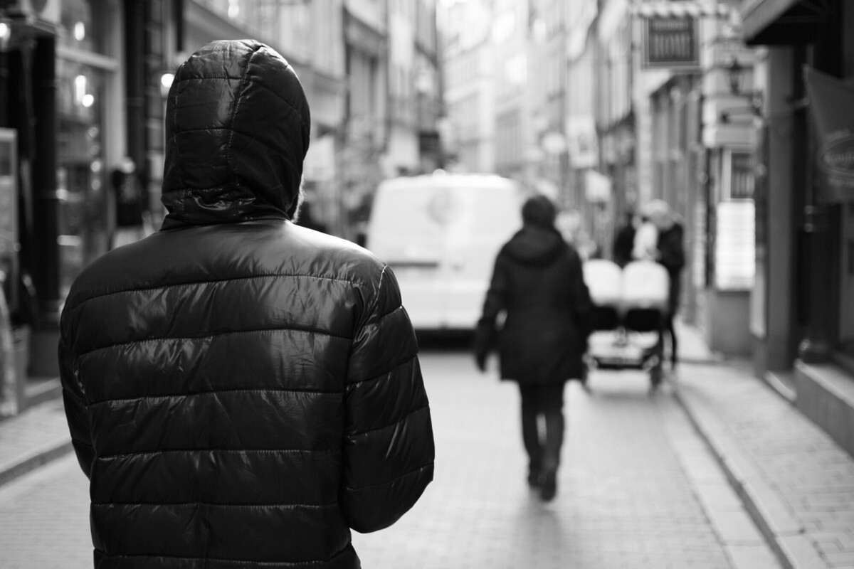 Homem perseguindo mulher na rua