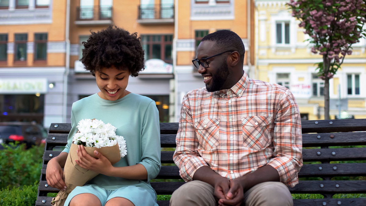 Homem dando flores a uma mulher de Áries