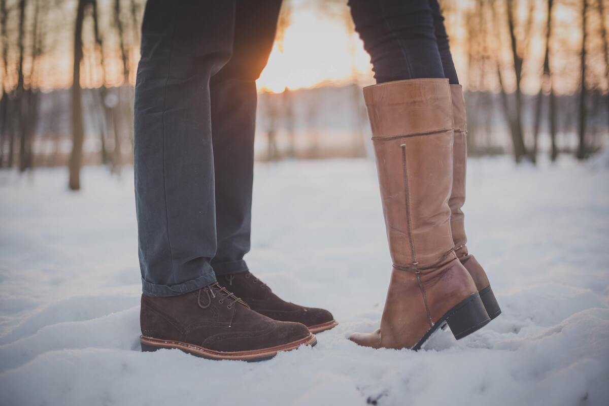 Pés de um casal na neve.