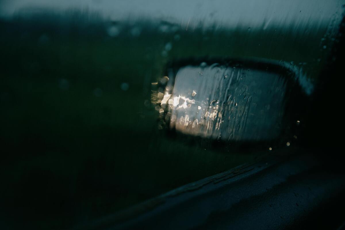 Retrovisor de carro em estrada chuvosa