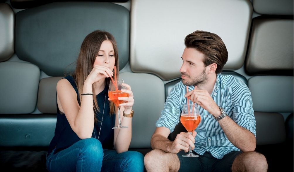 Casal tomando um drink laranja juntos