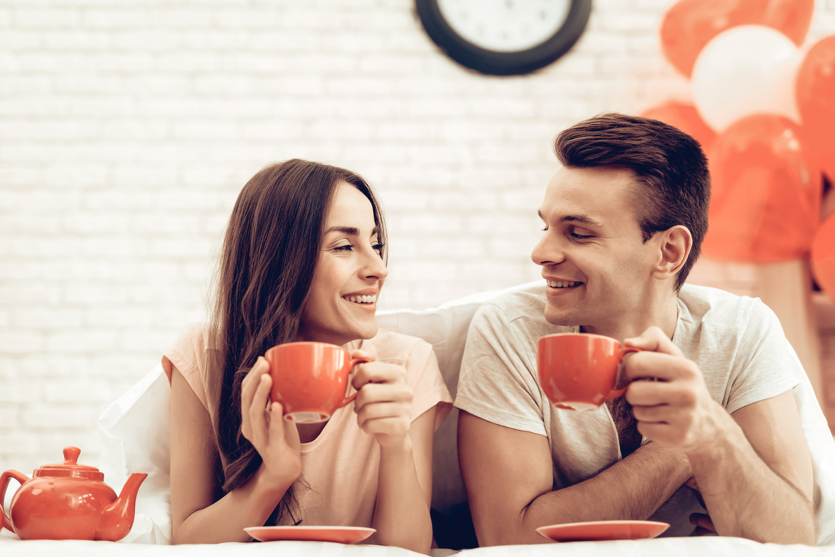 Um homem e uma mulher com xícaras nas mãos